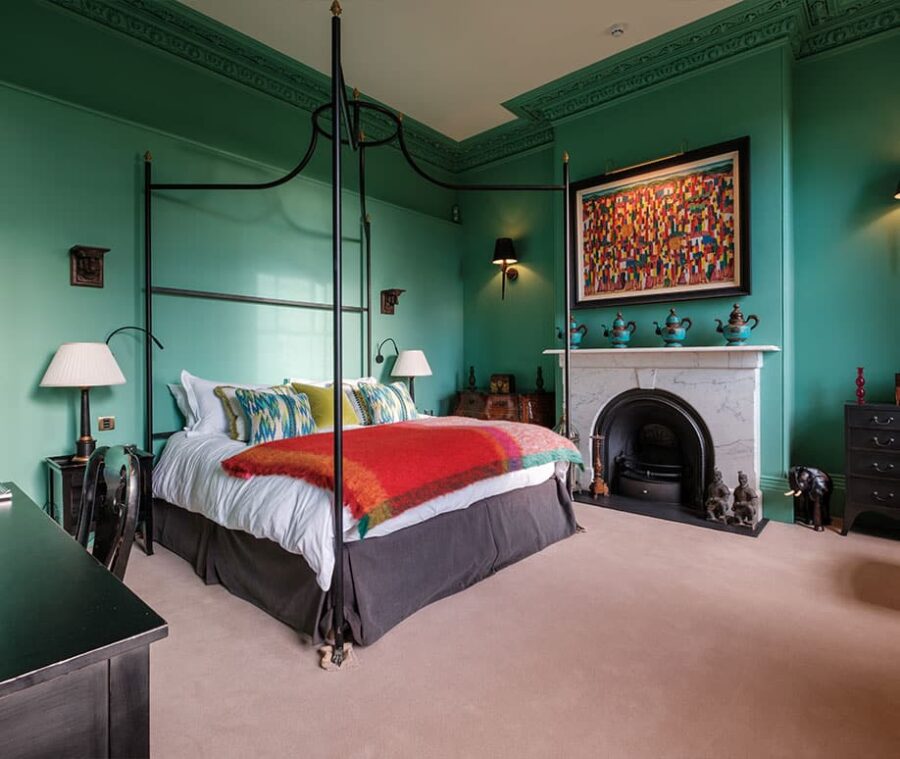 The Alice Prinsep room at Hotham Hall with green walls and a four-poster bed